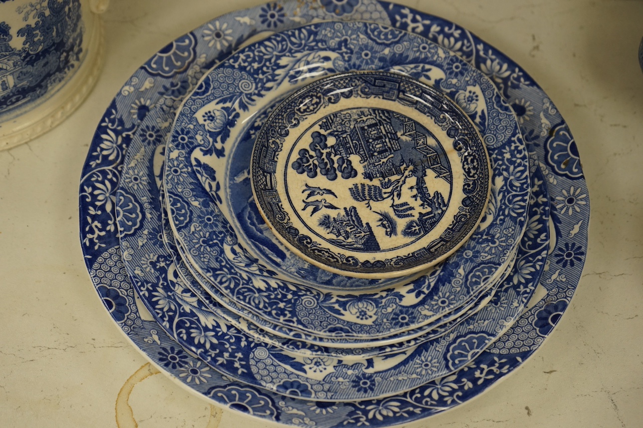 A group of blue and white ceramics to include Ironstone cheese dome and jug, a basin and twin handled cups, largest 36cm in diameter. Condition - varies